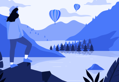 A hiker stands on a rocky ledge above a mountain lake, watching two hot-air balloons drift over the valley.